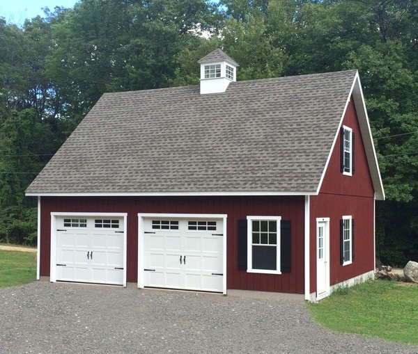 A red garage with two white doors.