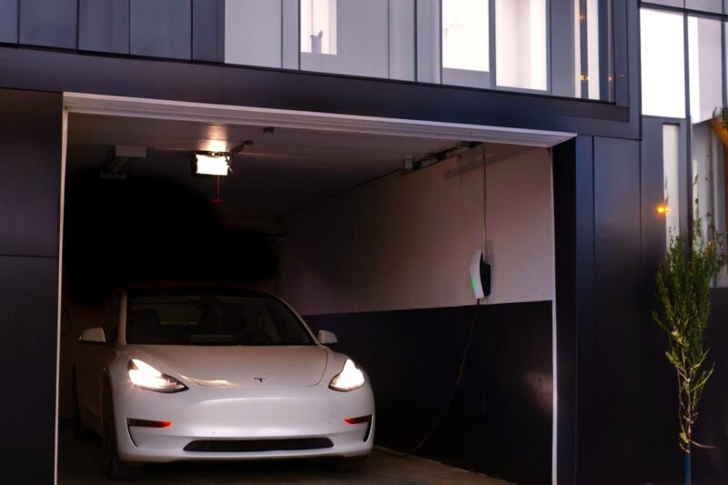 A modern garage with a nice car inside.