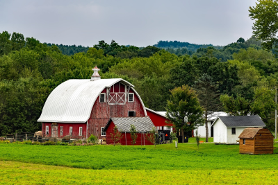 A scenic view of an amish red barn.